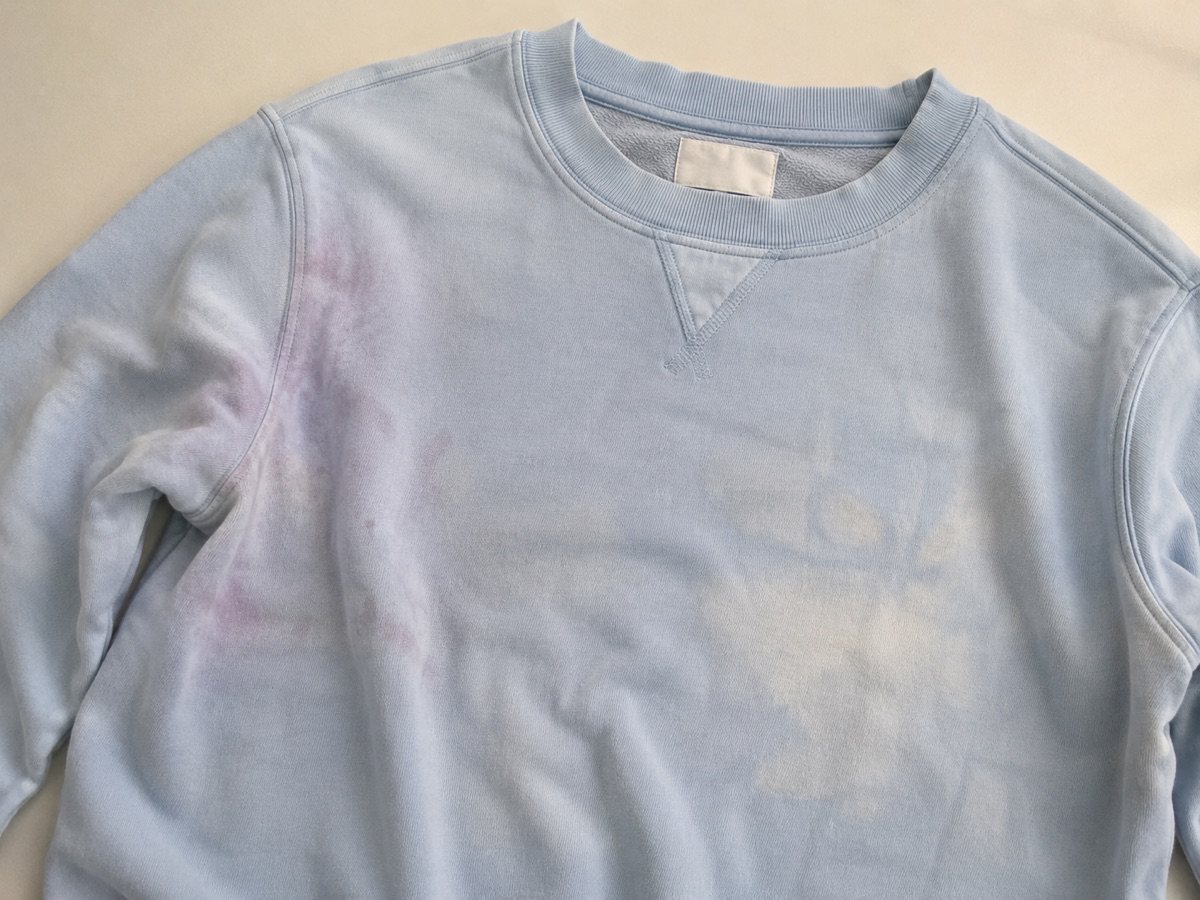 A white garment stained by color transfer in the wash