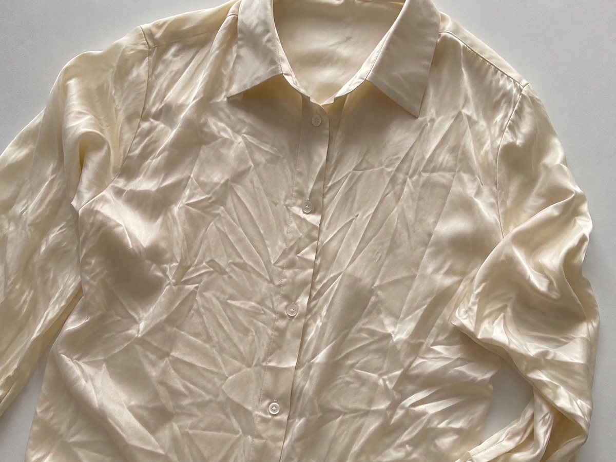 Deep creases across a wrinkled shirt